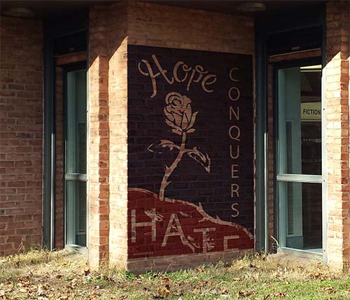 hope conquers hate on outside wall of library