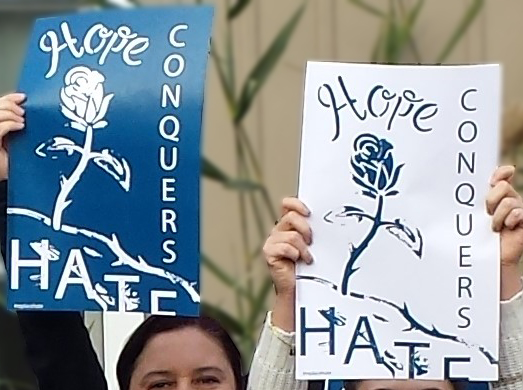 holding hope conquers hate poster